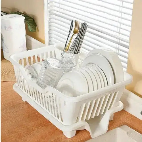 White dish rack with dishes on a kitchen counter