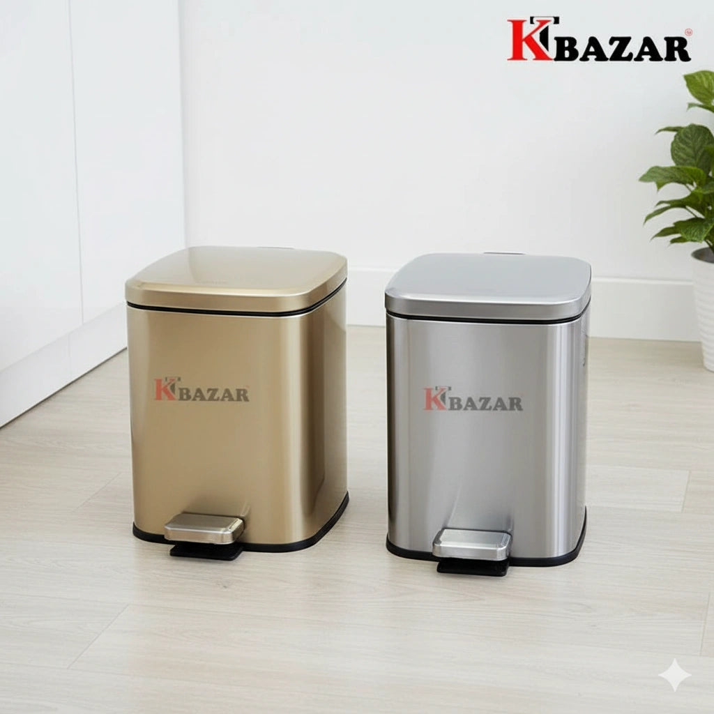 Two metallic trash bins, one gold and one silver, on a light wooden floor with a white wall background. The brand 'KBazar' is visible on the bins.