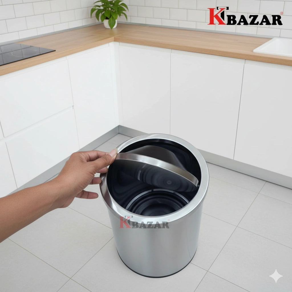 Person opening a metallic trash bin in a kitchen with Kbazar branding.