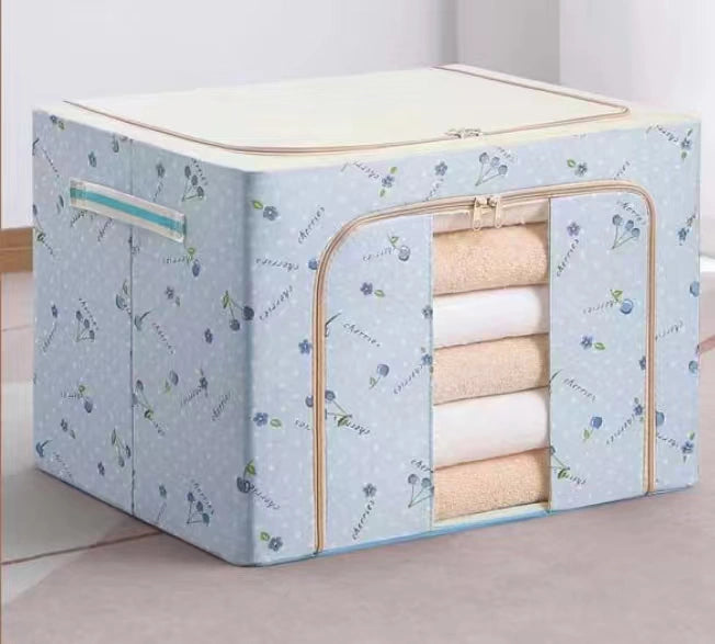 Floral-patterned storage box with folded clothes inside on a light background
