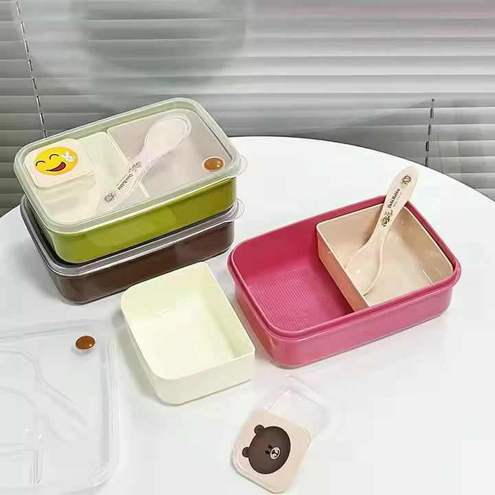 Set of colorful plastic containers with lids and spoons on a white surface.