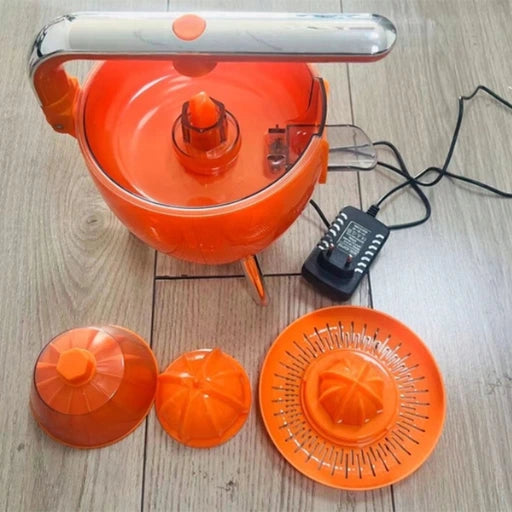 Orange kitchen appliance with attachments on a wooden surface