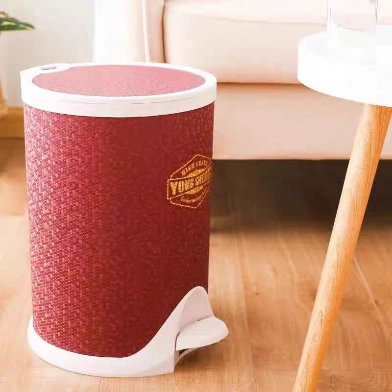 Red textured trash bin with white base on a wooden floor