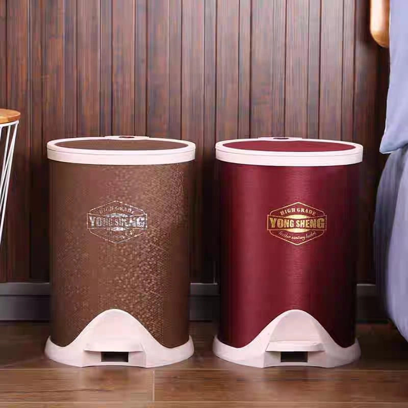Two trash bins, one brown and one red, with 'Yong Sheng' branding on a wooden floor.